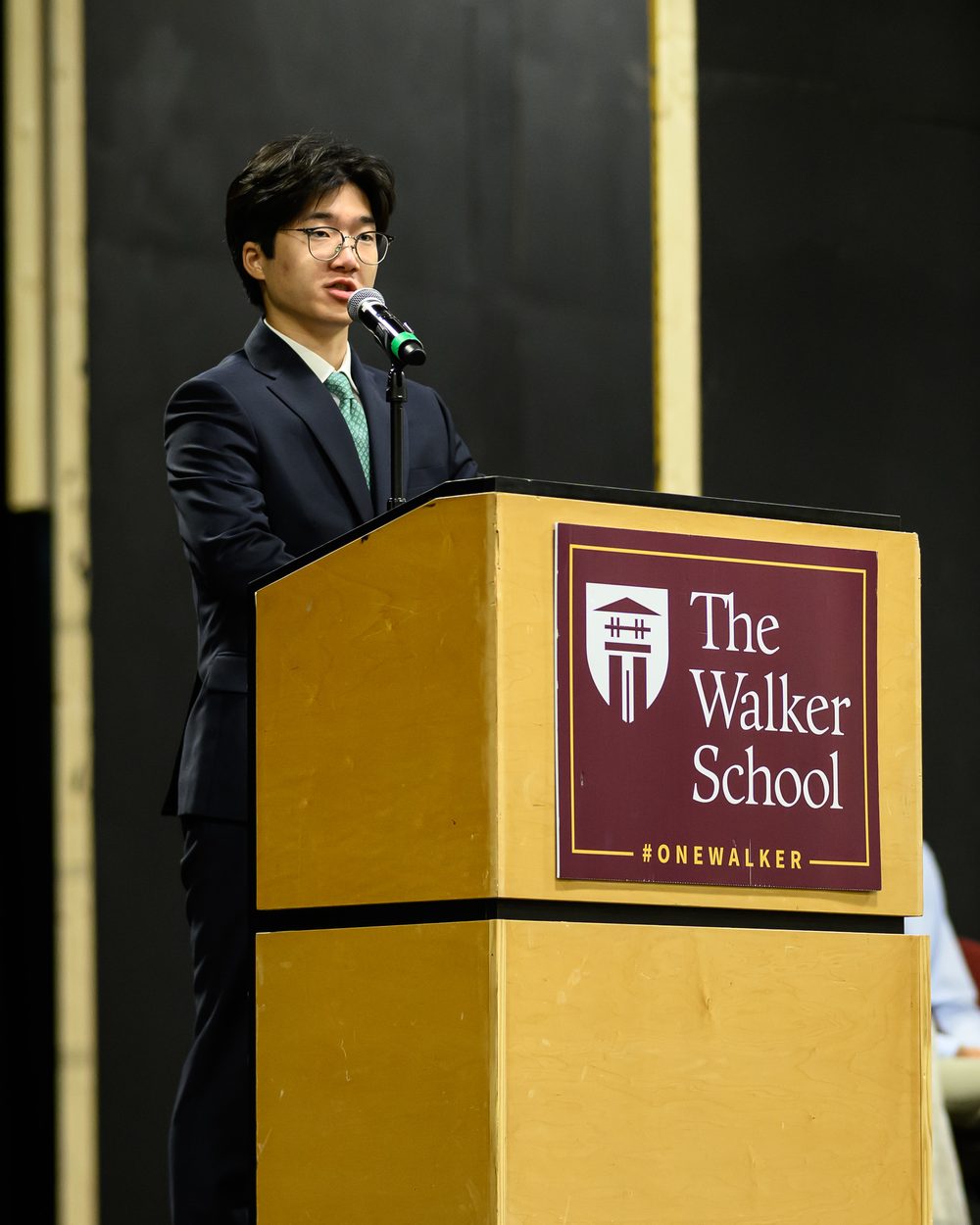 Yumin Lee speaking at a Walker School National Honor Society event